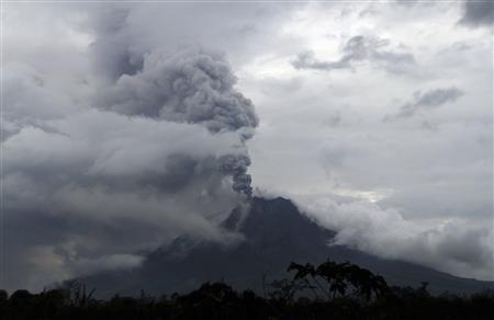 Mount Sinabung spew ash as it is pictured from Simpang Empat village in Karo district